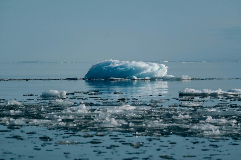 A serene view of a melting iceberg in the Arctic, symbolizing climate change impact.