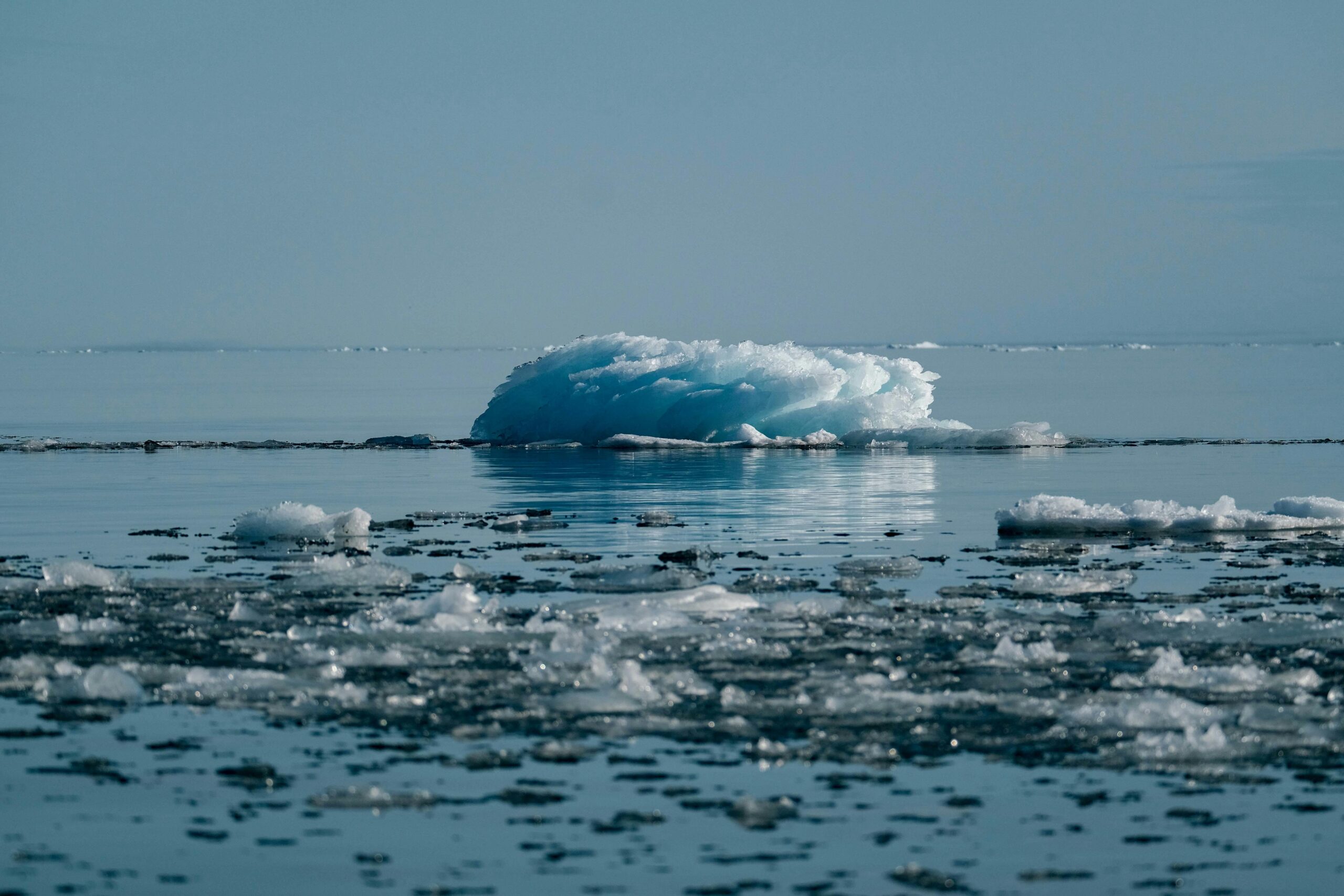 A serene view of a melting iceberg in the Arctic, symbolizing climate change impact.