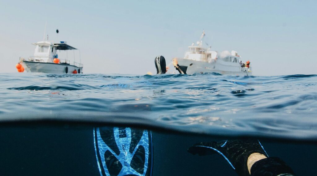 Experience the thrill of scuba diving near yachts in the open ocean. Ideal for adventure seekers.