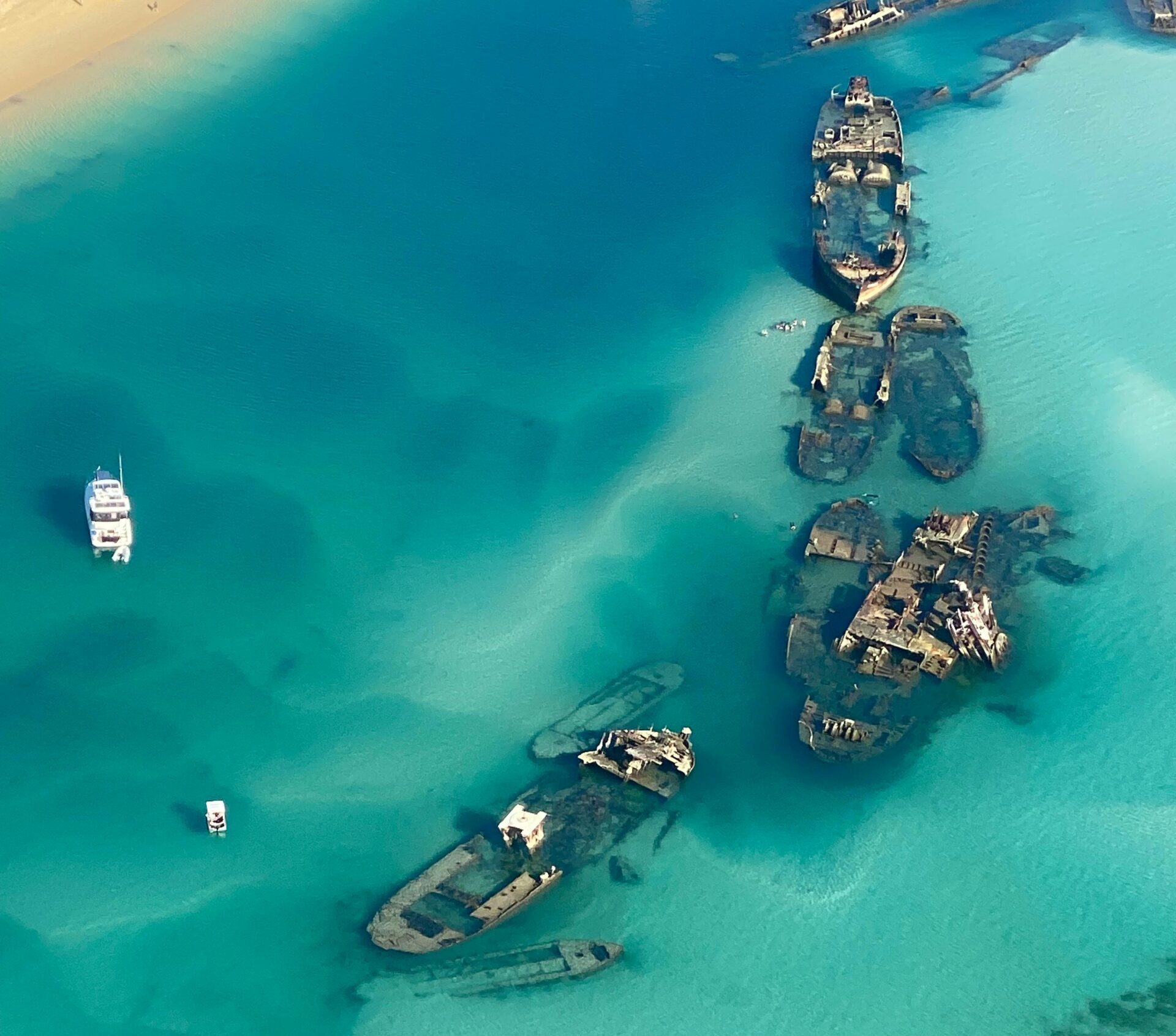 Aerial shot of shipwrecks in turquoise waters of Moreton Island, Australia.